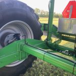 The GreenLoader drawbar, wheel and control box, with a red warning triangle on the frame.