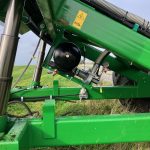 A hydraulic cylinder and a black pressure tank on the GreenLoader frame.