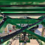 Hydraulic hoses running along the underside of a GreenLoader chassis.
