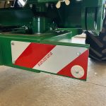 The red-and-white striped end plate on a GreenLoader drawbar.