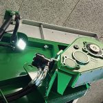 A hydraulic motor on a GreenLoader, lit by a small work light.