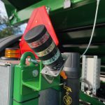 A tall multi-colour beacon mounted beside the GreenLoader control box.