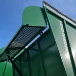 A mesh panel on the side of a GreenLoader, with GREEN LOADER lettering on the body.