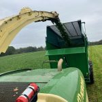 View from a forage harvester as its spout pours crop into a GreenLoader.