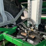 Hydraulic hoses and a drive unit at the axle of a GreenLoader.