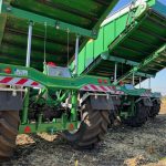 Low rear view of several GreenLoaders with their bodies raised in a field.