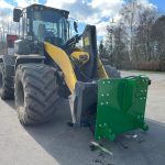 Front view of a PowerWinch blade on a large yellow wheel loader.