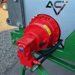 Close-up of a red hydraulic motor bolted to a PowerWinch frame.