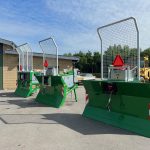 Three PowerWinch blades facing the camera in a sunny yard.