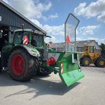 Front view of a Fendt tractor with an ACJ PowerWinch parked at a workshop door.