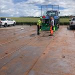 Two operators handling several wire ropes from an ACJ PW Twin Power on a concrete pad.